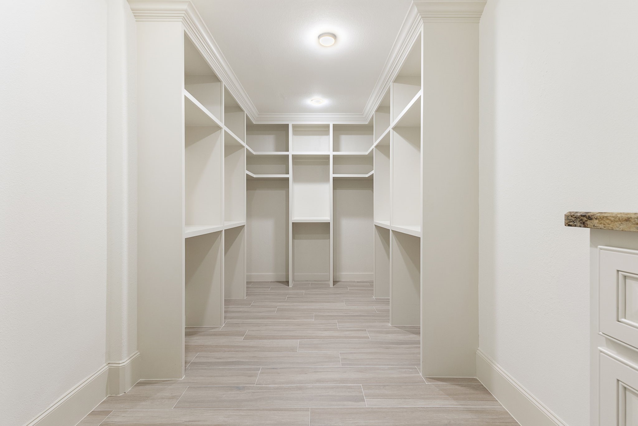 27502 Whispering Maple Way Spring, TX 77386 - Photo 22 of 46 The sellers expanded this spacious main walk-in closet in the Primary Suite, complete with built-in dresser and dedicated shoe storage. Plus, enjoy the convenience of a secondary walk-in closet as well!