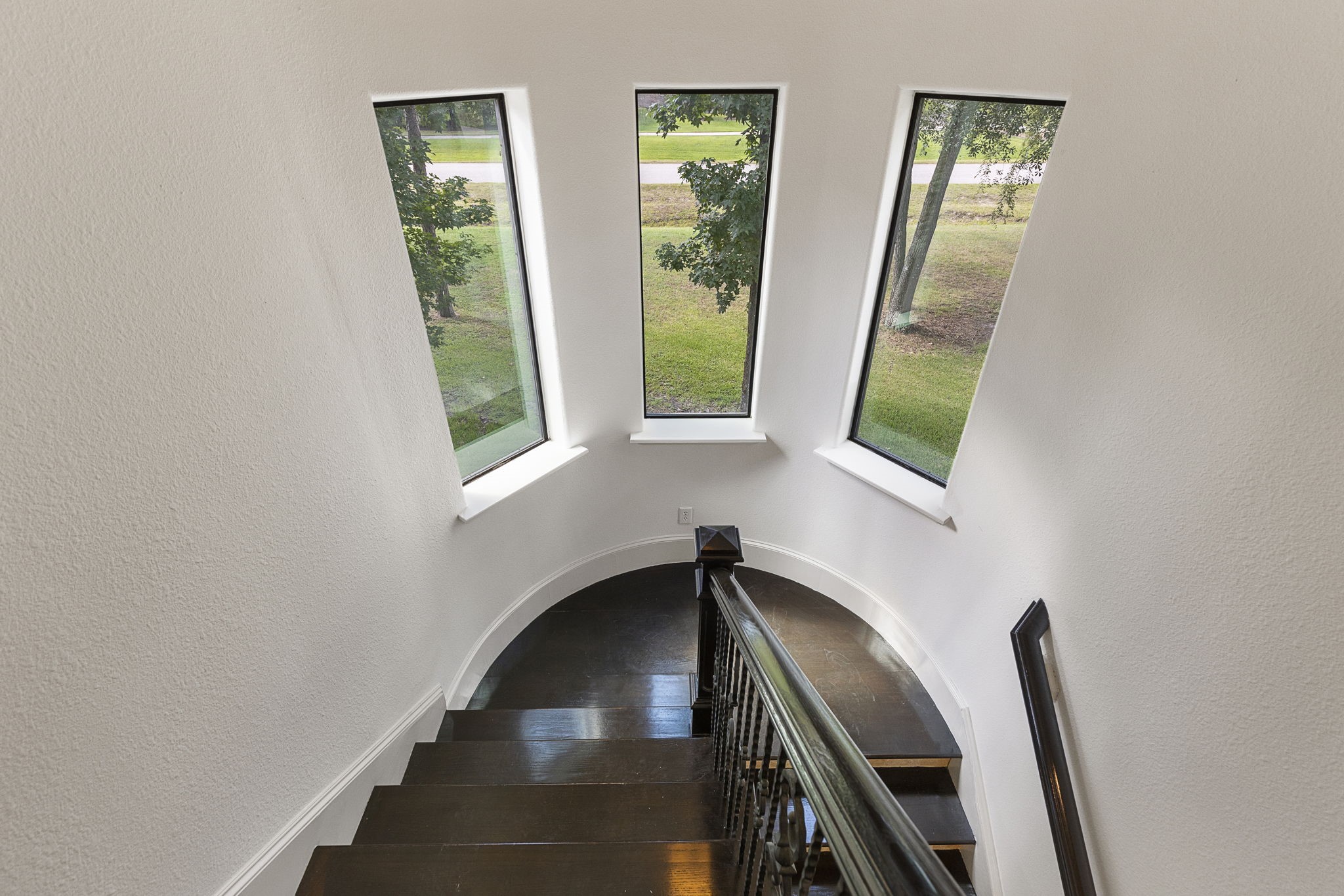 27502 Whispering Maple Way Spring, TX 77386 - Photo 27 of 46 Beautiful winding wood staircase with tile risers and scenic windows, conveniently located just off the kitchen.