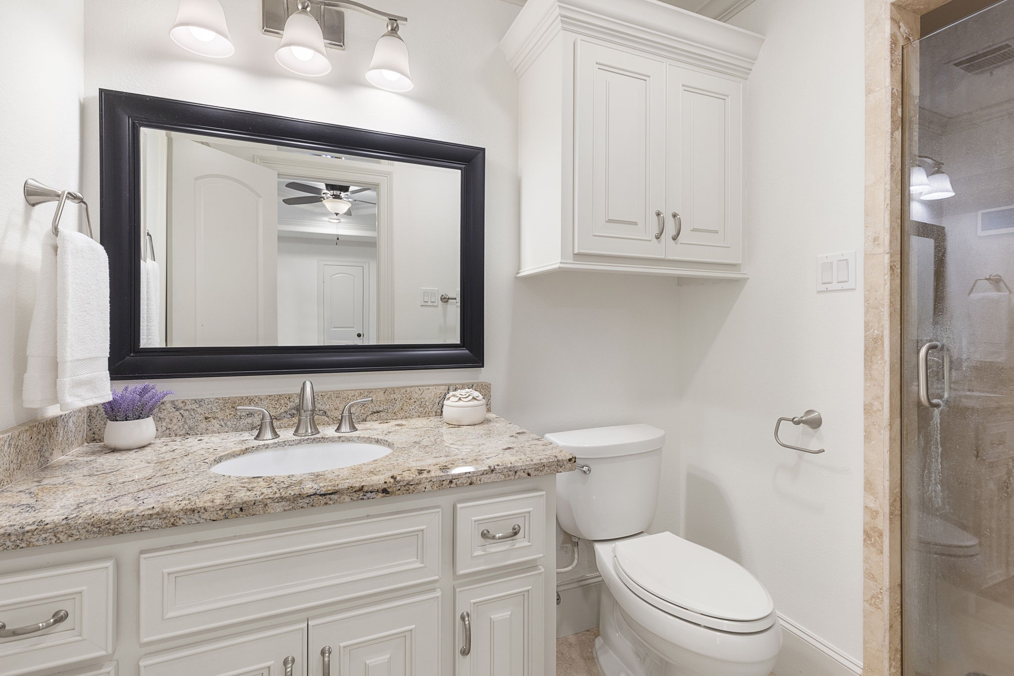 27502 Whispering Maple Way Spring, TX 77386 - Photo 32 of 46 a bathroom with a granite countertop toilet sink and mirror