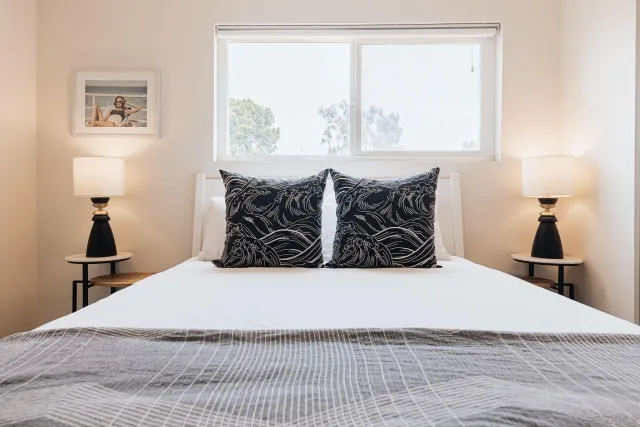 a bed room with a bed and a large mirror