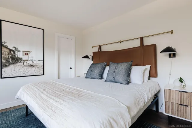 a bathroom with a sink a mirror a vanity and shower