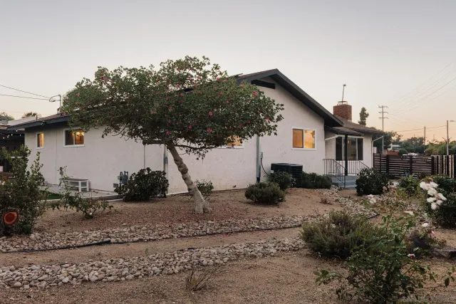 a kitchen with stainless steel appliances a table chairs and a refrigerator