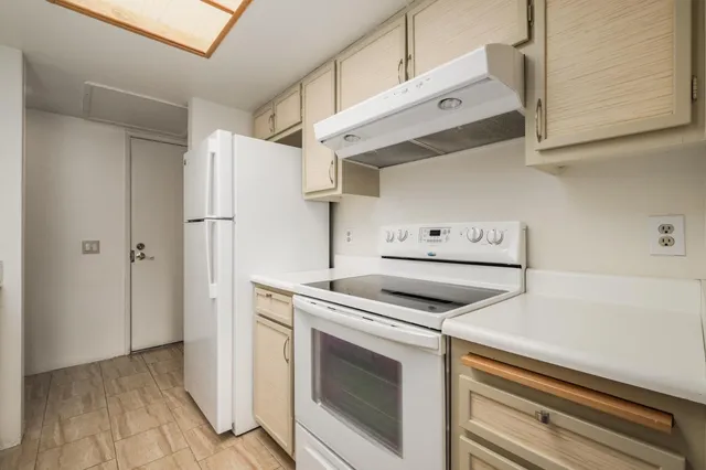 a kitchen with stainless steel appliances granite countertop a sink and a white cabinets