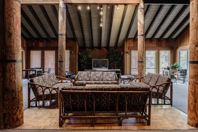 a backyard of a house with barbeque oven table and chairs