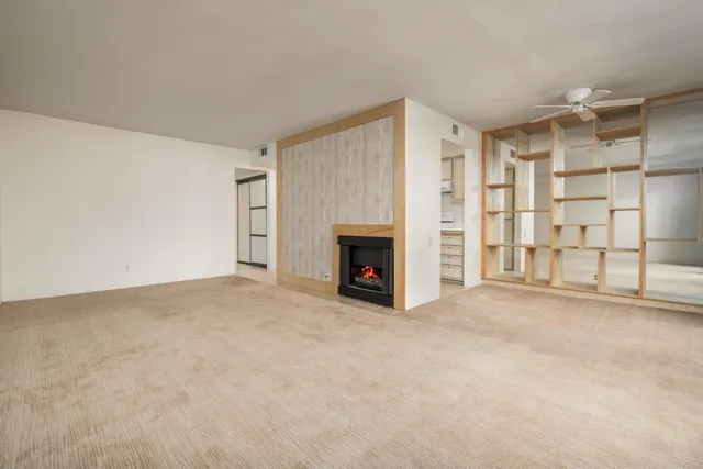 a view of an empty room with glass door