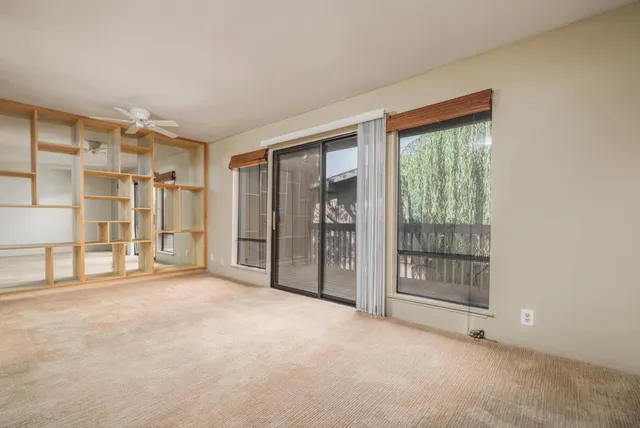 a view of a livingroom with a fireplace and window