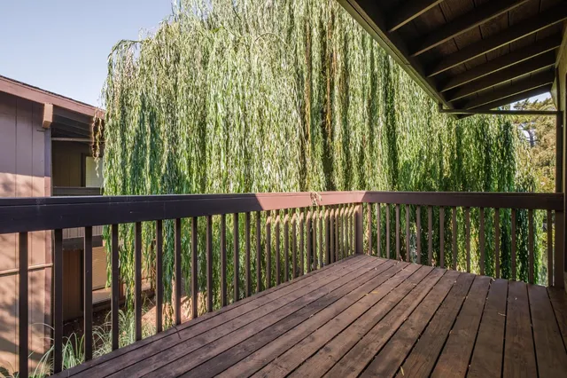 a view of balcony with wooden floor
