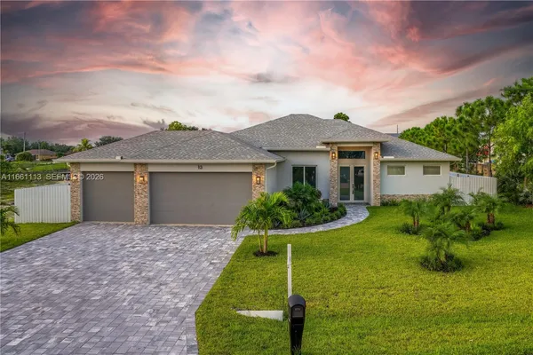 a front view of house with yard and green space
