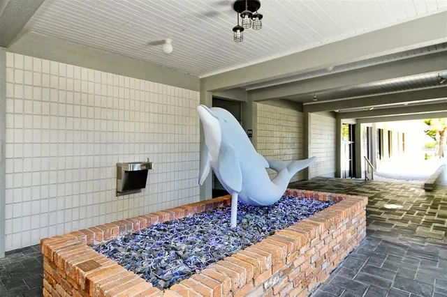 an empty room with wooden floor fireplace and windows
