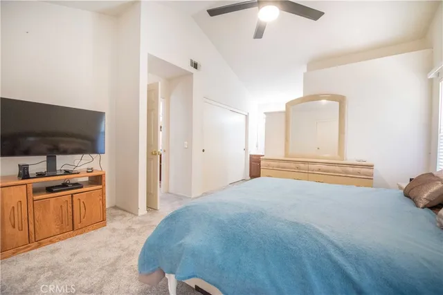 a bedroom with a bed and a television