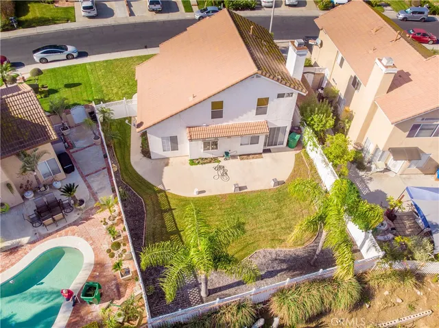 an aerial view of a house with a yard and potted plants