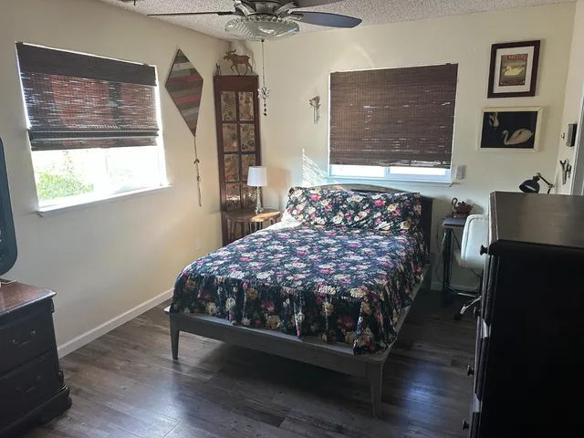 a bed sitting in a bedroom next to a window