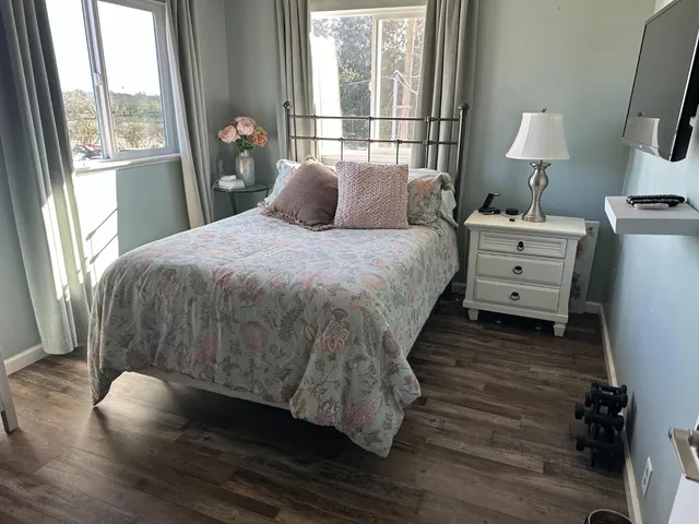 a bedroom with a bed and a window
