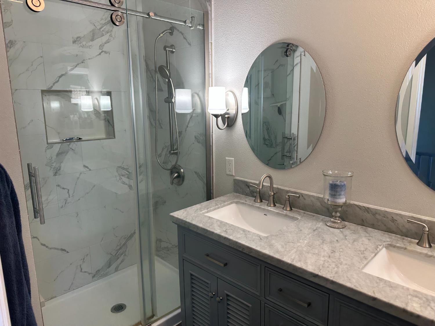6186 Arena Way Livingston, CA 95334 - Photo 10 of 21 a bathroom with a double vanity sink mirror and shower