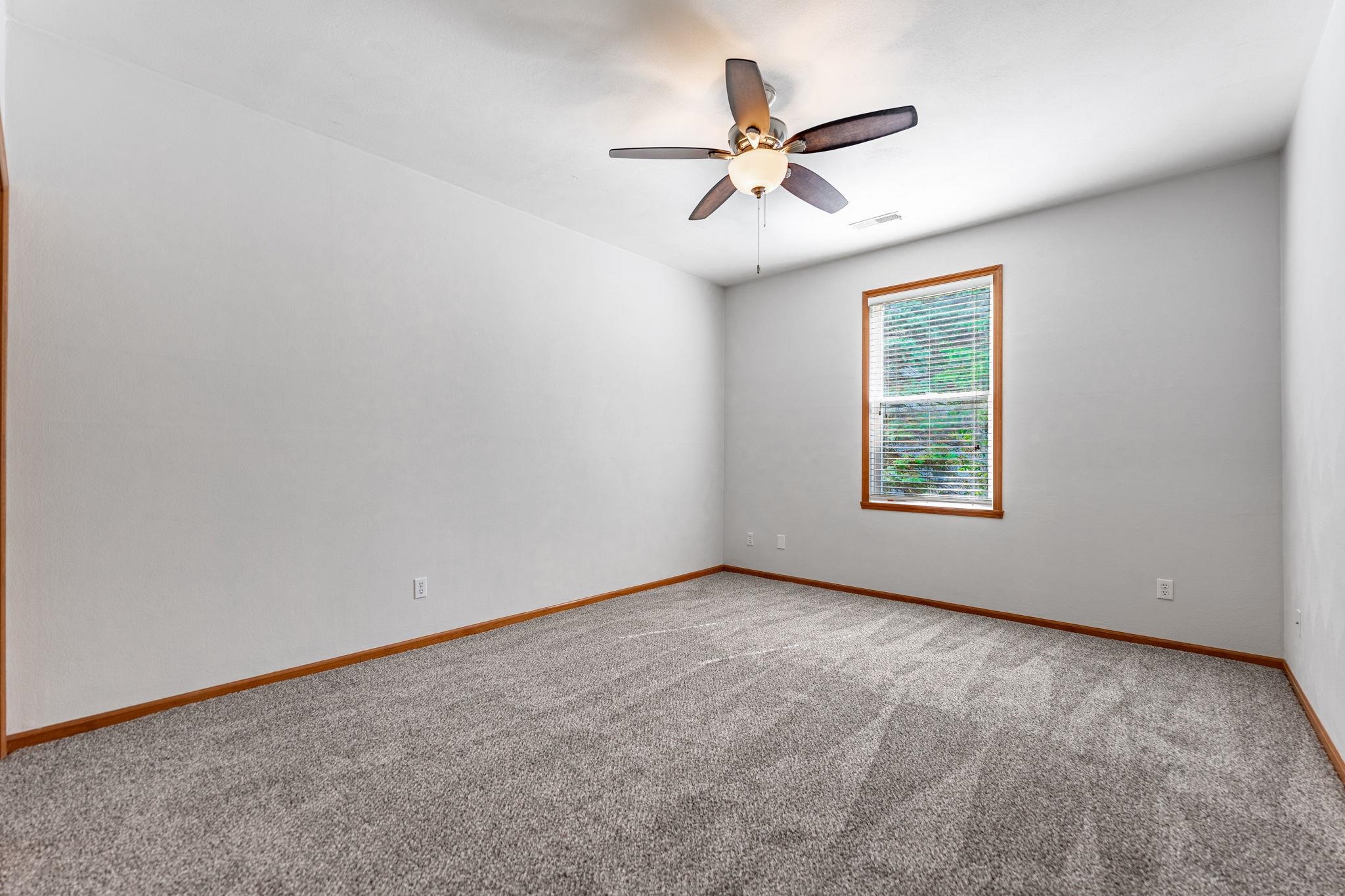 10113 Monarch Road Roscoe, IL 61073 - Photo 12 of 20 an empty room with windows and fan