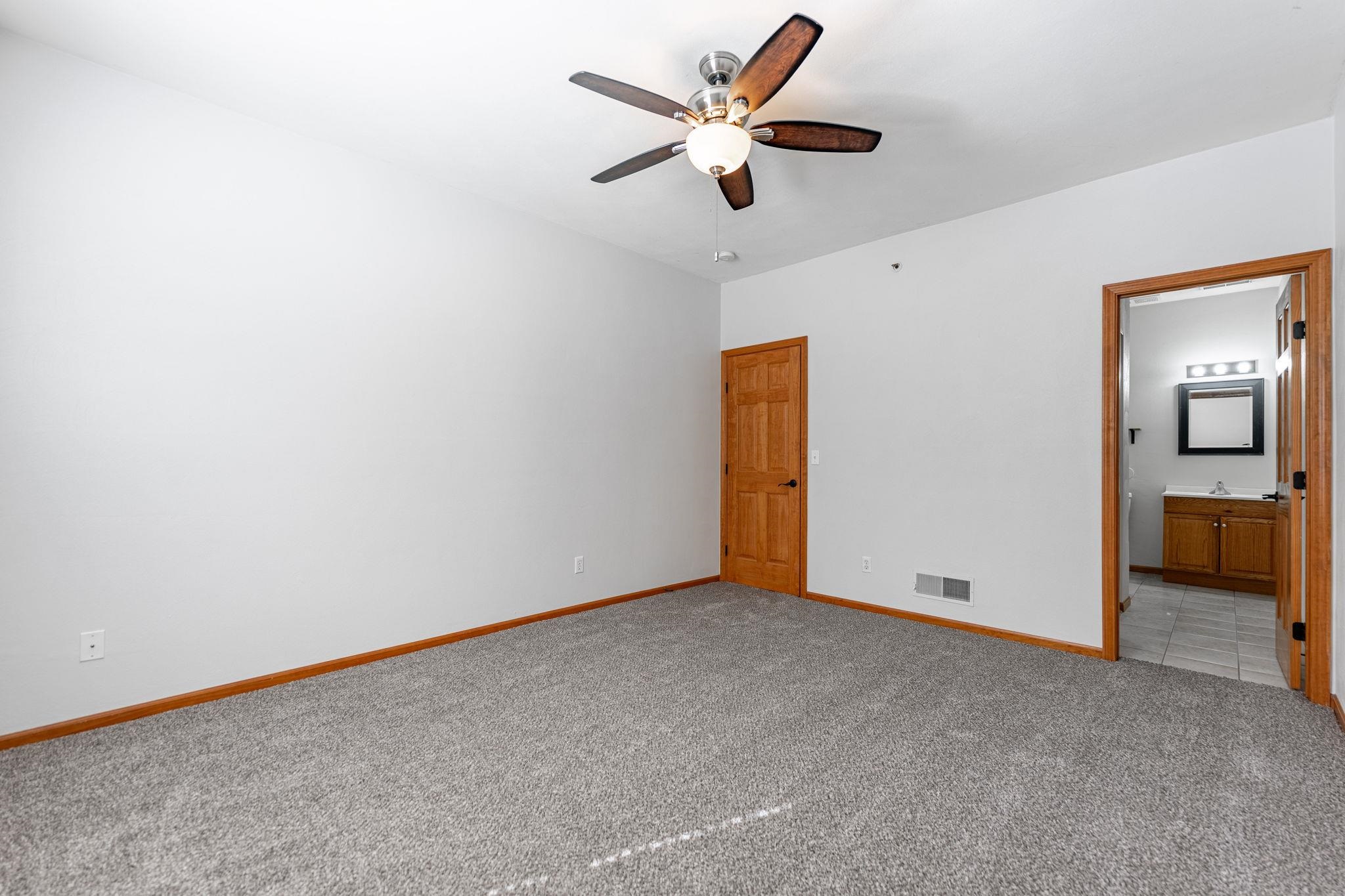 10113 Monarch Road Roscoe, IL 61073 - Photo 13 of 20 an empty room with a ceiling fan and a window