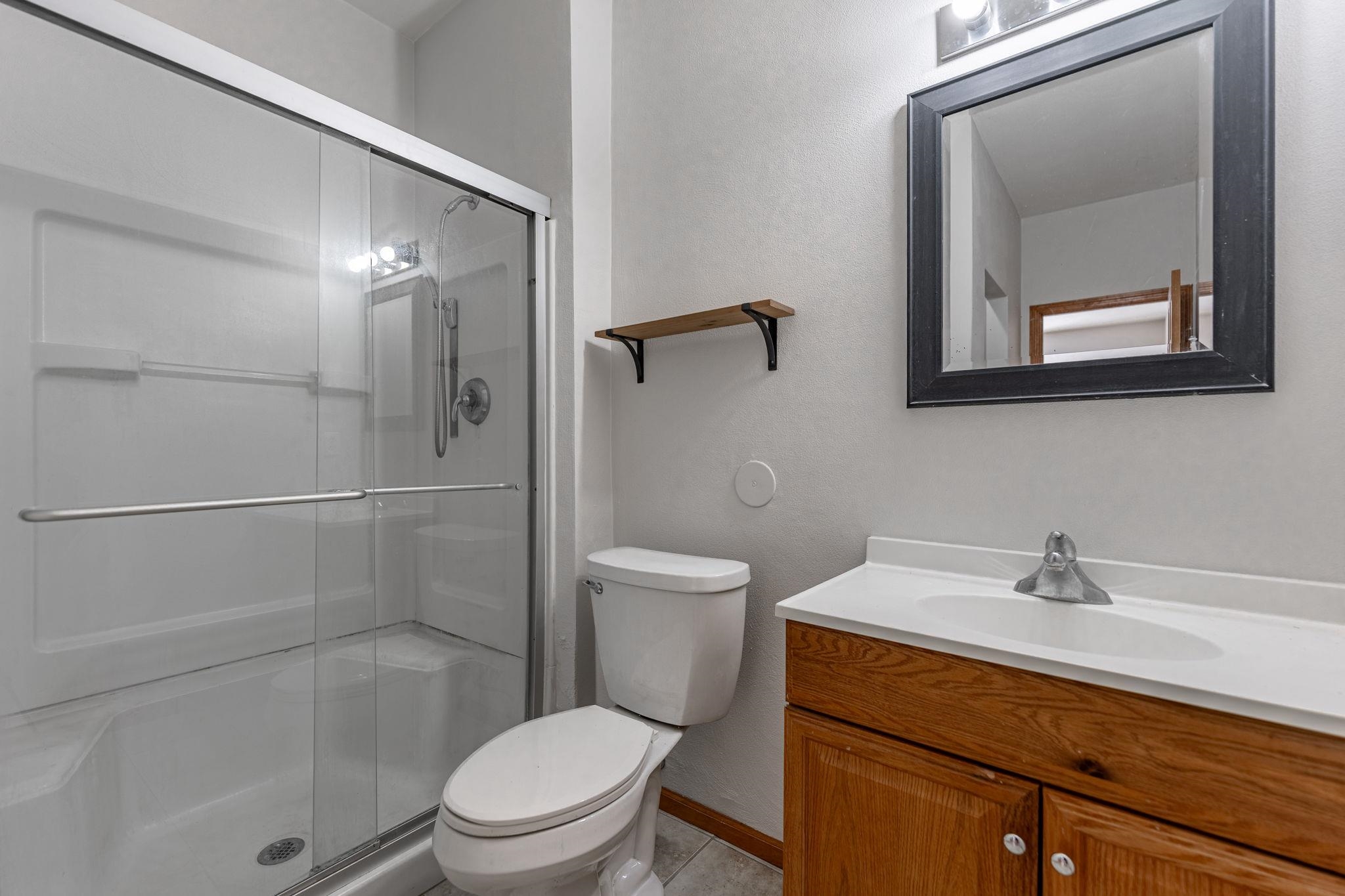 10113 Monarch Road Roscoe, IL 61073 - Photo 16 of 20 a bathroom with a toilet a sink and shower