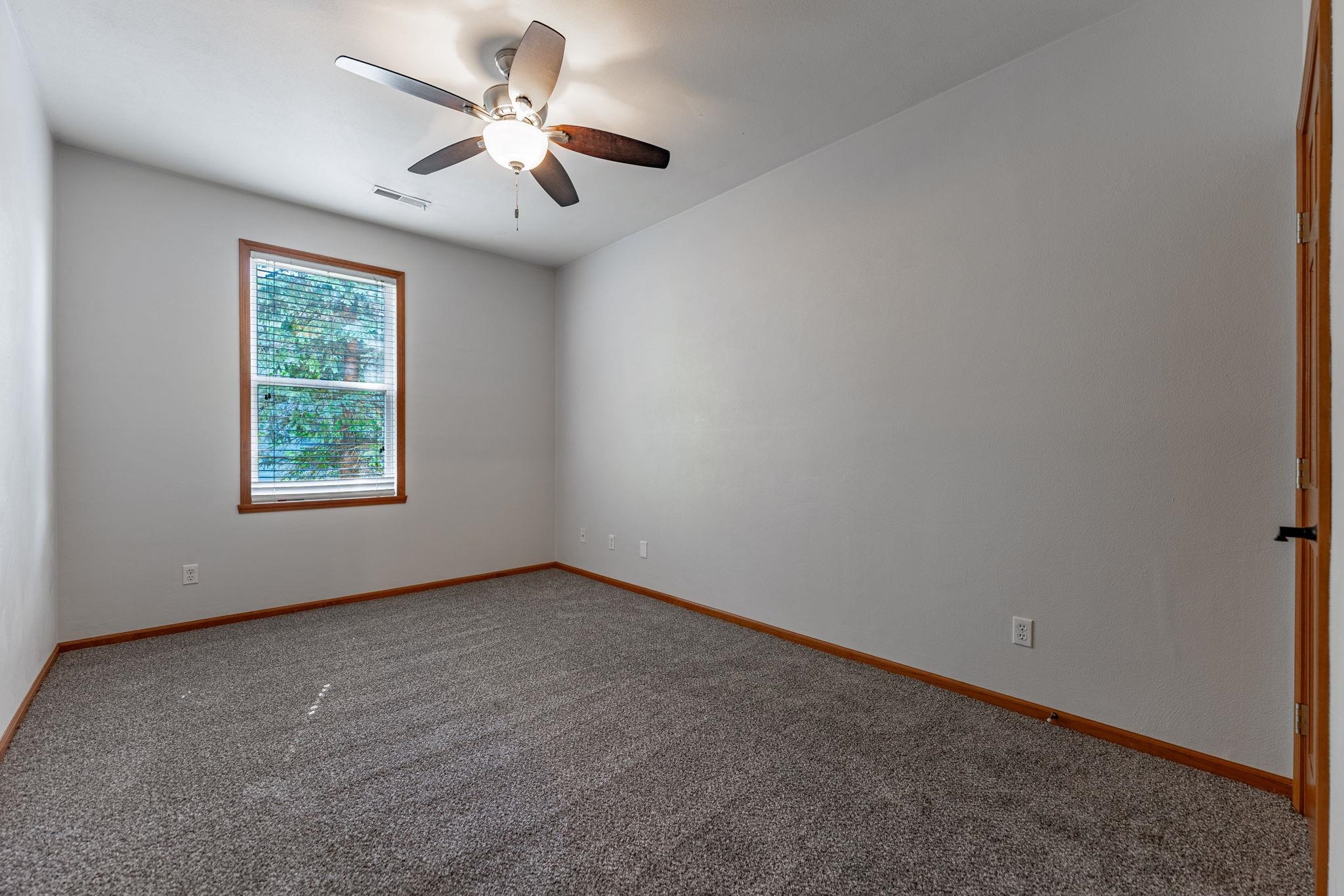10113 Monarch Road Roscoe, IL 61073 - Photo 17 of 20 an empty room with windows and fan