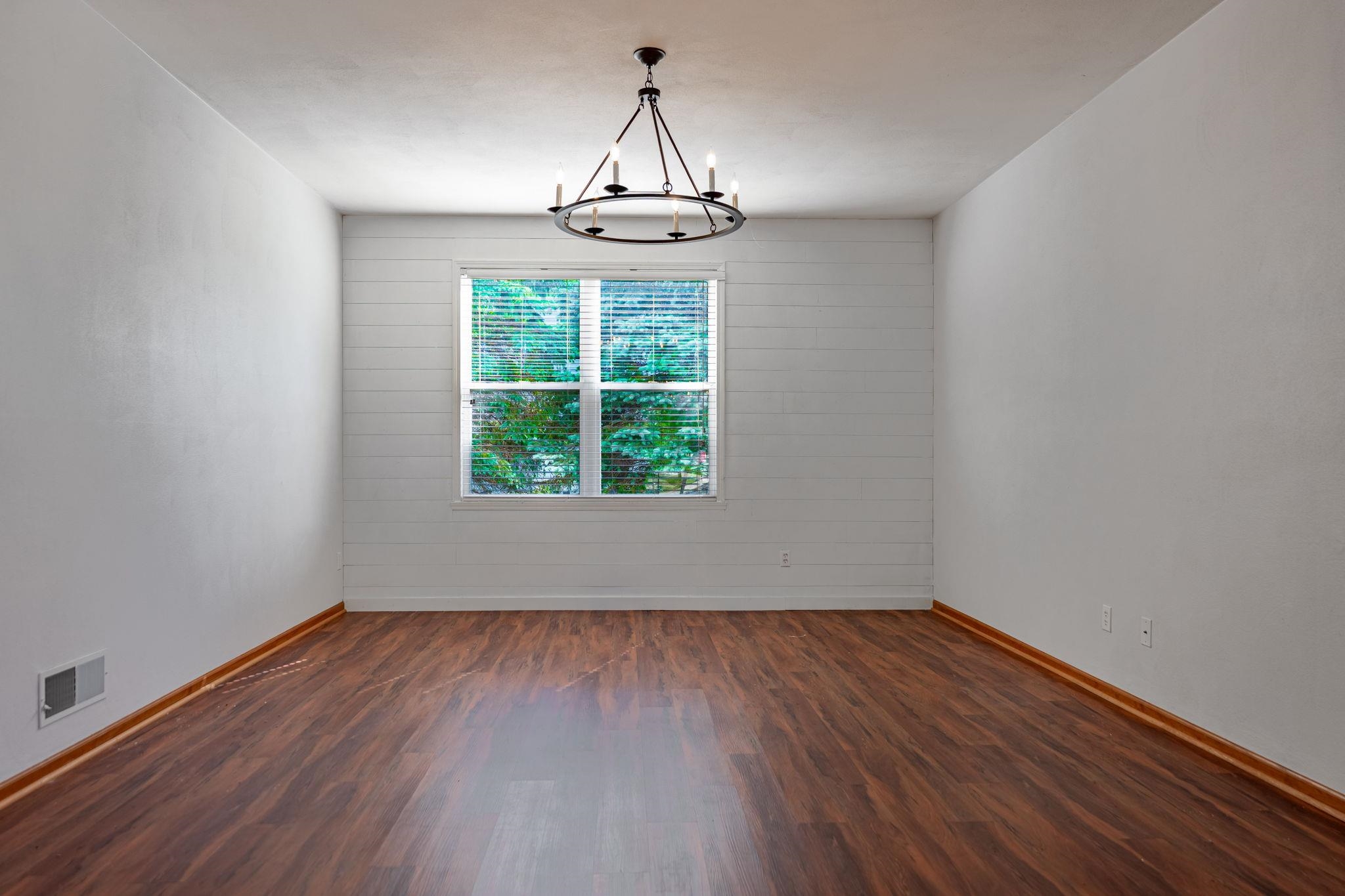 10113 Monarch Road Roscoe, IL 61073 - Photo 8 of 20 a view of an empty room with wooden floor and a window
