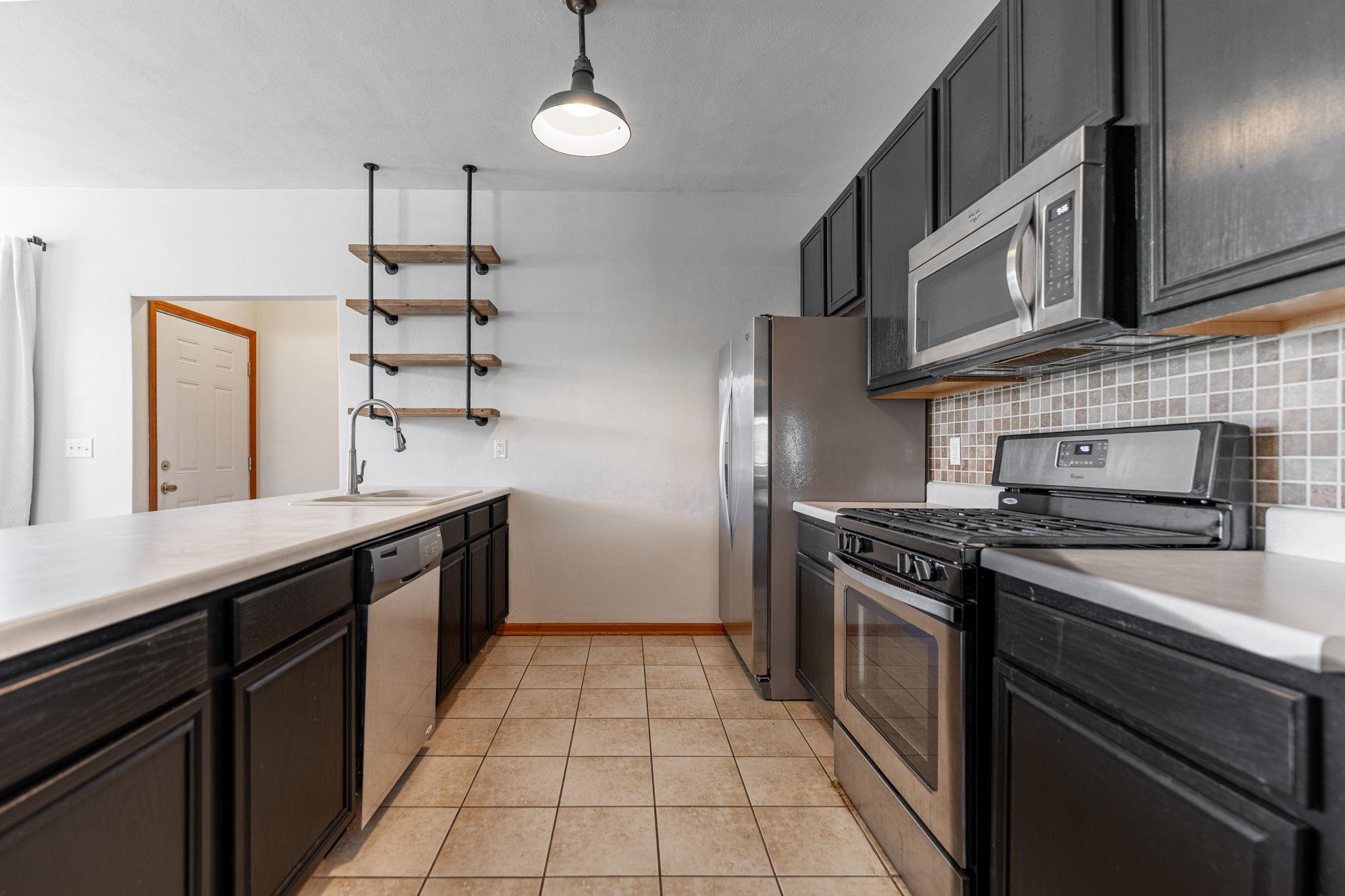10113 Monarch Road Roscoe, IL 61073 - Photo 10 of 20 a kitchen with stainless steel appliances granite countertop a stove and a sink