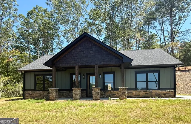a view of a house with pool and sitting area