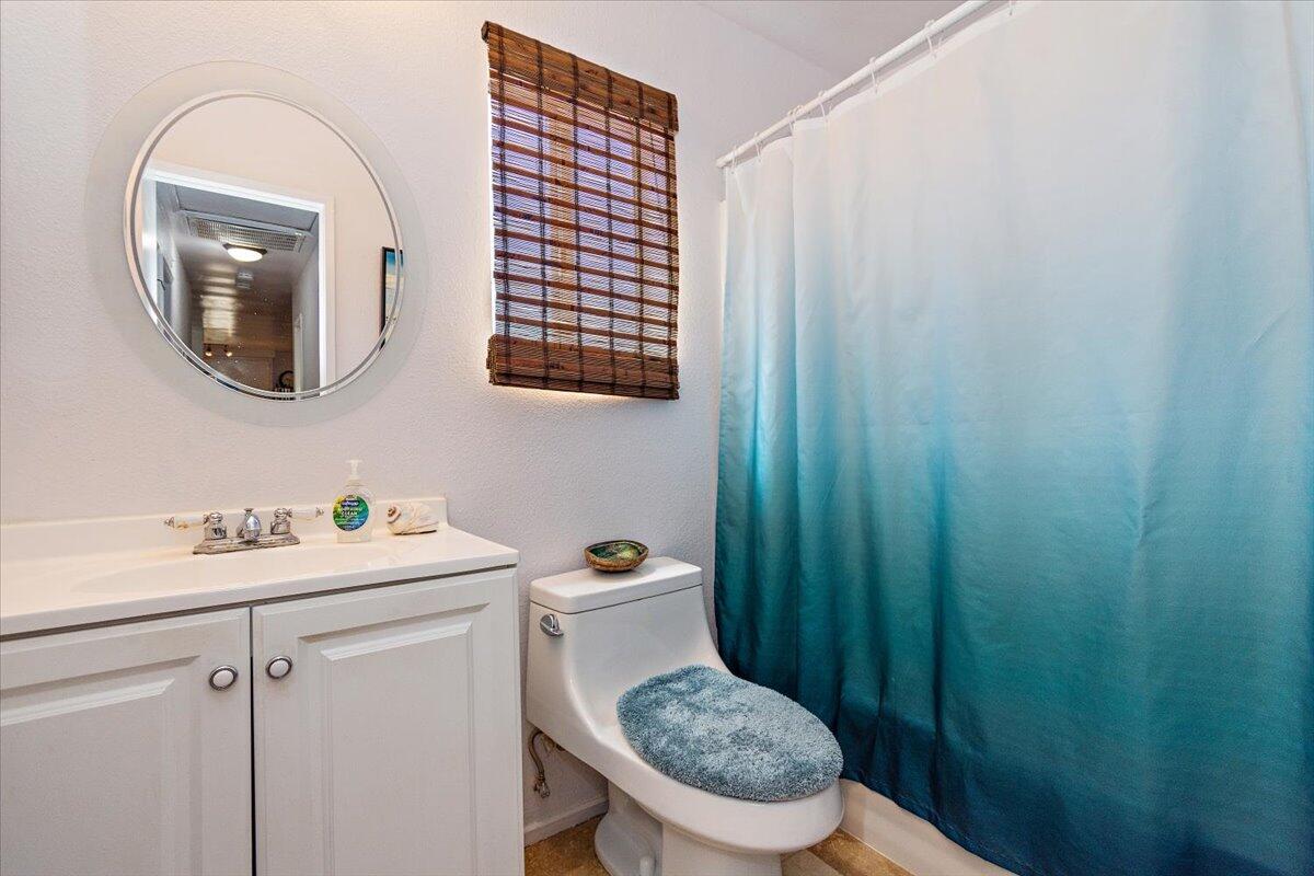 51884 Ida Avenue Cabazon, CA 92230 - Photo 14 of 25 a bathroom with a toilet a sink and a mirror