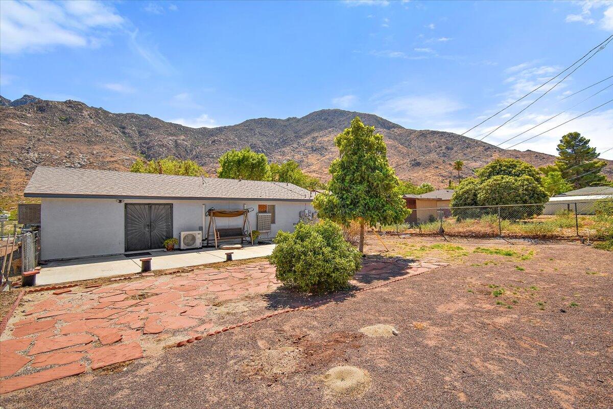 51884 Ida Avenue Cabazon, CA 92230 - Photo 19 of 25 a house with a mountain in the background