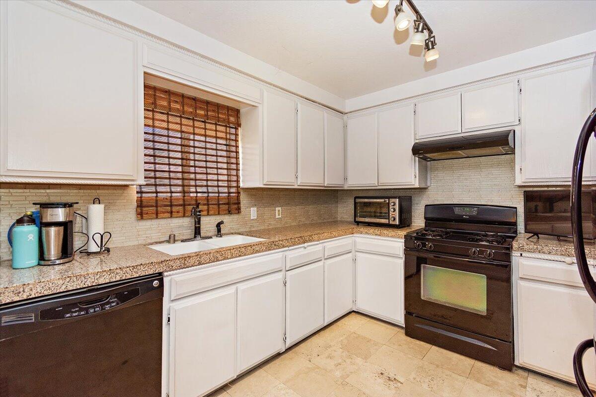 51884 Ida Avenue Cabazon, CA 92230 - Photo 6 of 25 a kitchen with granite countertop a stove sink and cabinets