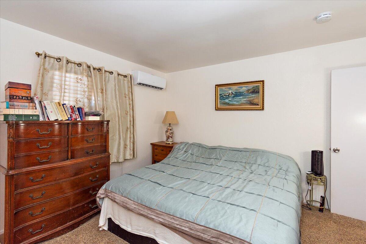 51884 Ida Avenue Cabazon, CA 92230 - Photo 10 of 25 a bedroom with a bed and a dresser