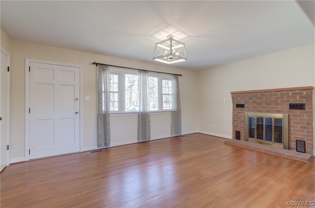 2341 Sheppard Town Road Maidens, VA 23102 - Photo 12 of 45 an empty room with wooden floor chandelier and windows