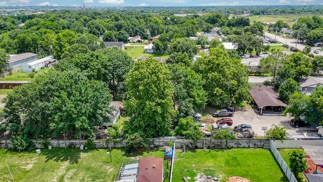 an aerial view of a house with a yard and lake view