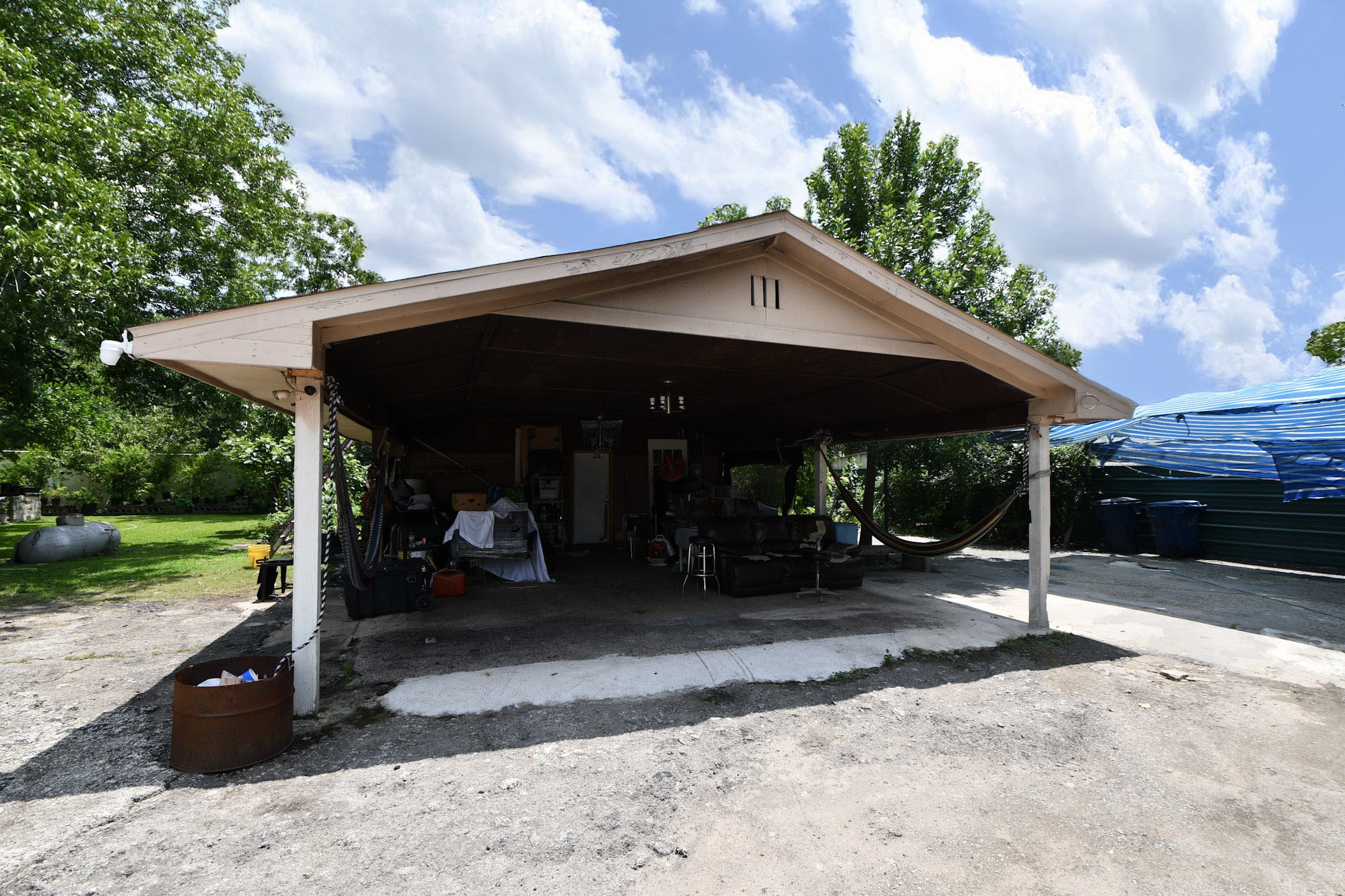 16005 Old Richmond Road Sugar Land, TX 77498 - Photo 16 of 46 a view of a patio with table and chairs under an umbrella