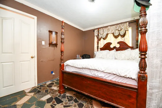 a bedroom with a bed and a window