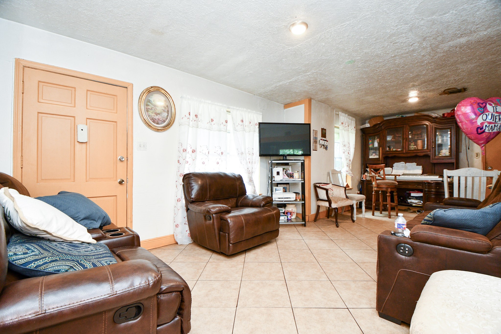 16005 Old Richmond Road Sugar Land, TX 77498 - Photo 22 of 46 a living room with furniture and a flat screen tv