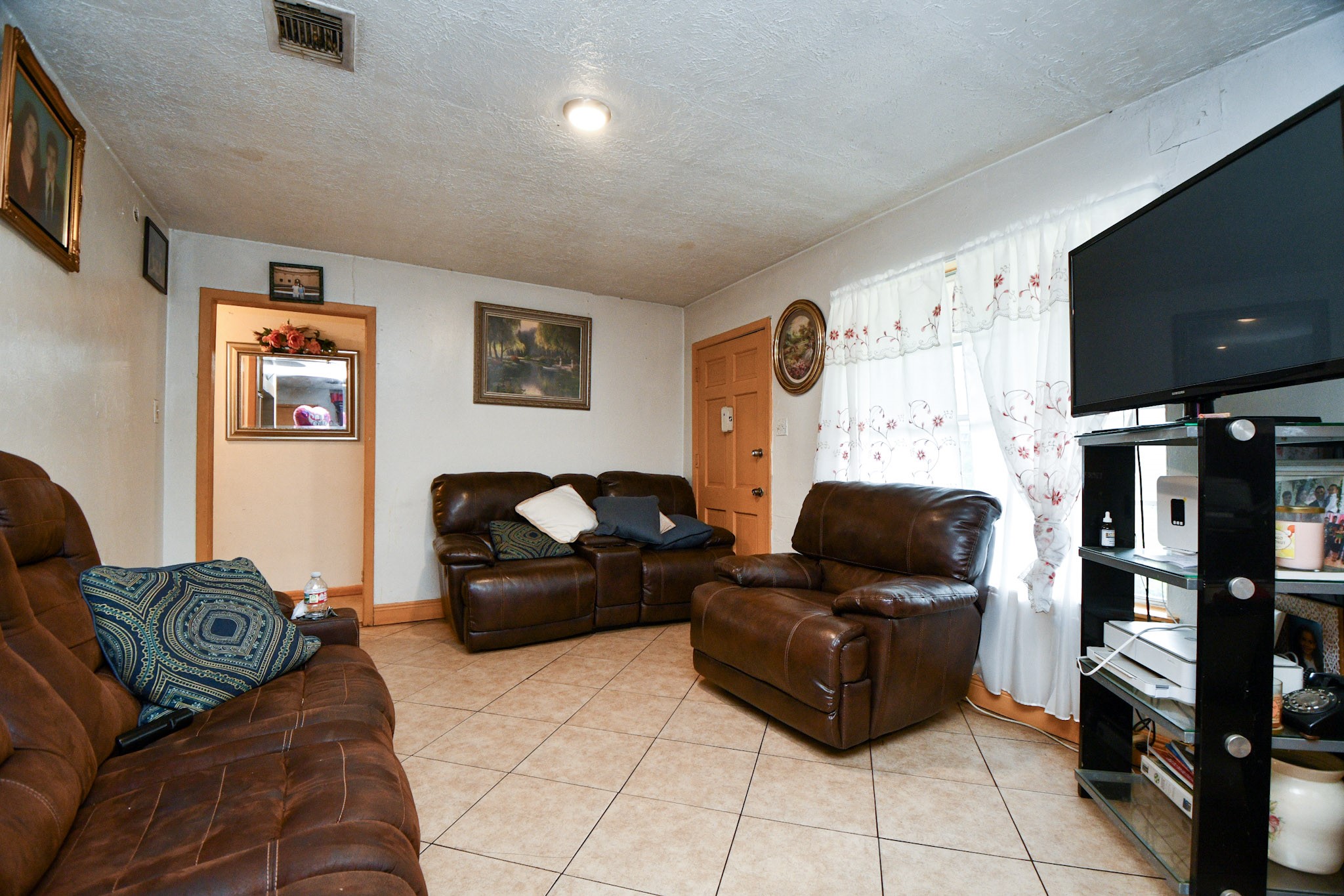 16005 Old Richmond Road Sugar Land, TX 77498 - Photo 24 of 46 a living room with furniture and a flat screen tv