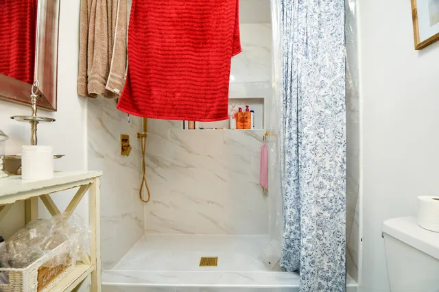 a bathroom with a bathtub and shower
