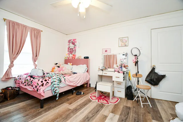 a bed room with a bed mirror and a window