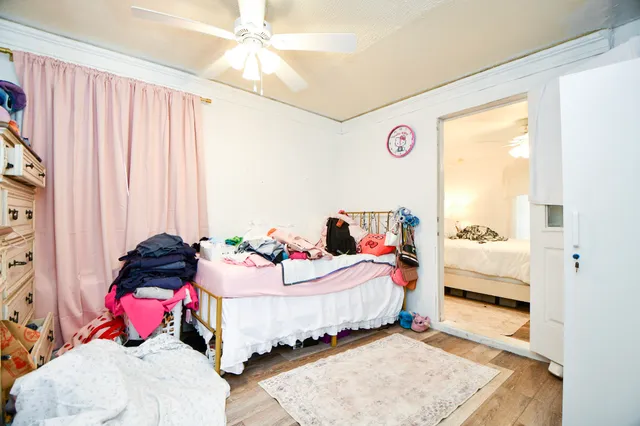 a bedroom with a bed and a window