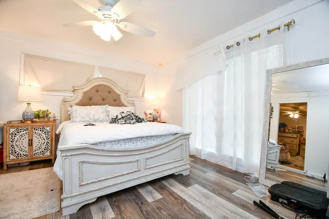 a bedroom with a bed and a chandelier