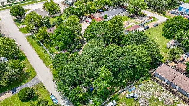 an aerial view of residential house with outdoor space and trees all around