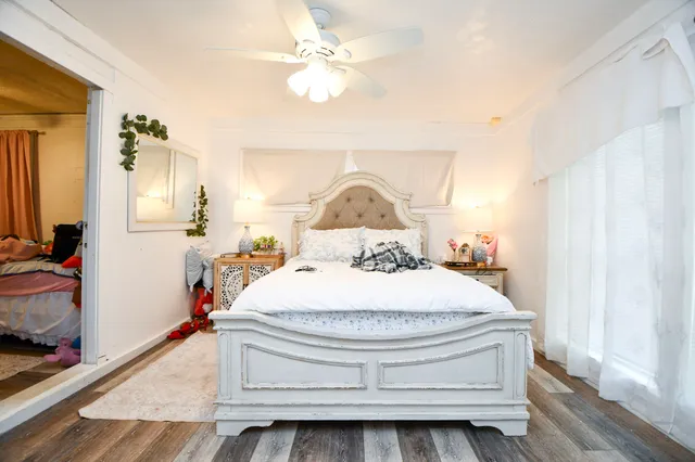 a bedroom with a bed and a chandelier