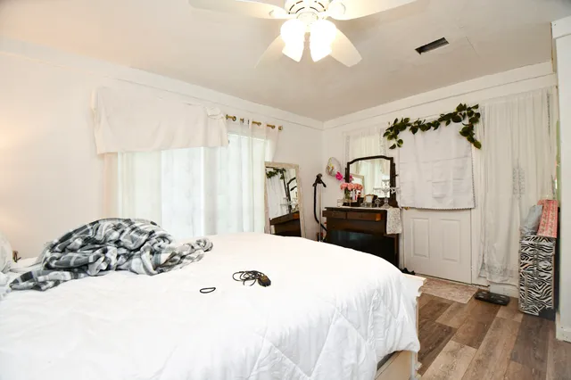 a bedroom with a bed and a window