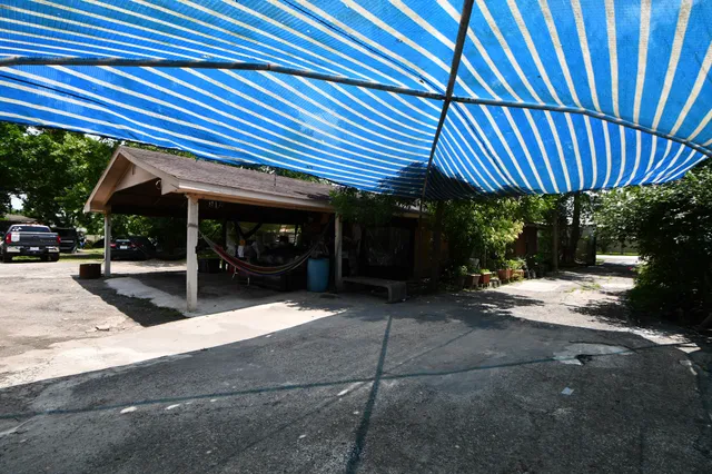 a view of a house with backyard porch and sitting area
