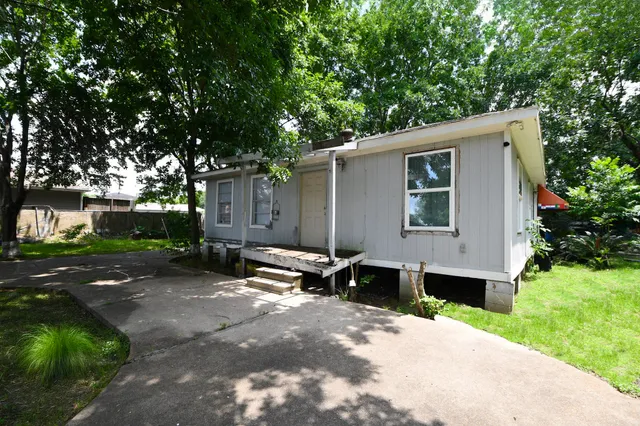 a view of a house with backyard and sitting area