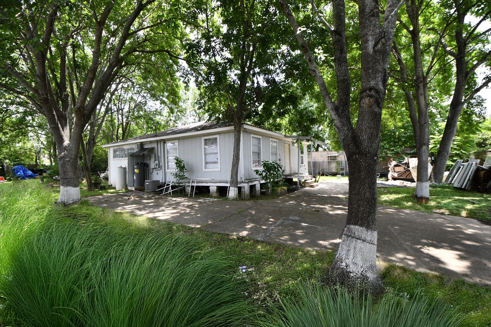16005 Old Richmond Road Sugar Land, TX 77498 - Photo 6 of 46 a view of a yard in front of a house with large tree