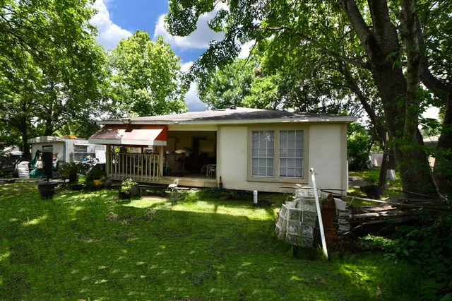 a view of a house with backyard sitting area and garden
