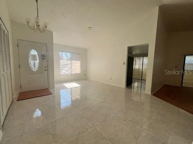 a view of a room with window and hardwood floor