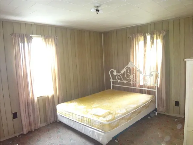a bed sitting in a bedroom next to a window