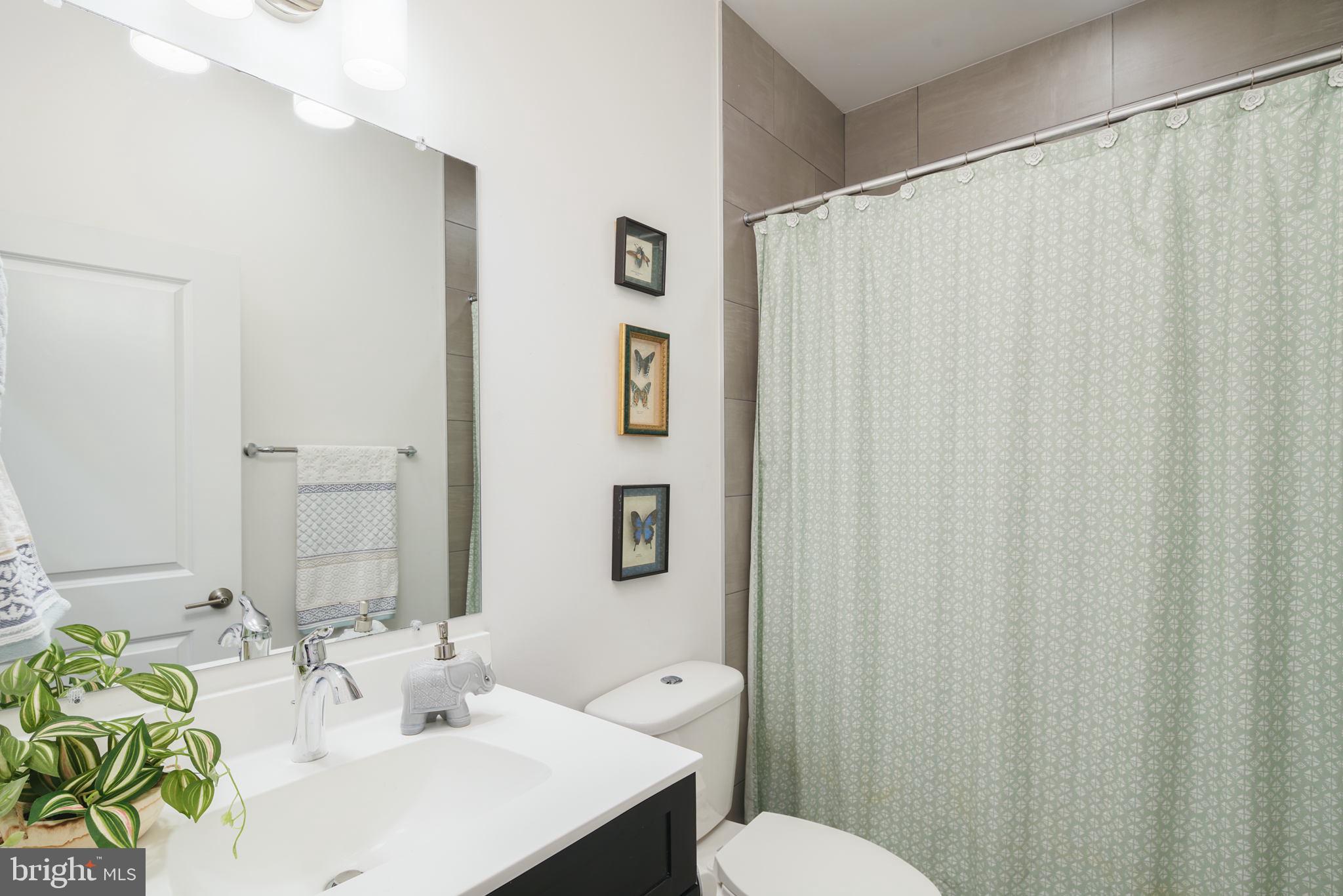 159 East Allen Street, Unit 1 Philadelphia, PA 19125 - Photo 31 of 45 a bathroom with a sink a mirror and a toilet