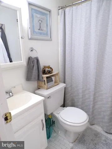 a white toilet sitting next to a bathroom sink